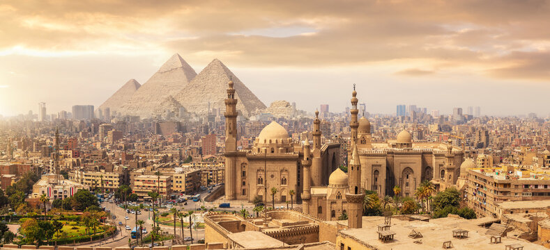 Historic Cairo Cityscape with Sultan Hassan Mosque and Great Pyramids in Giza, Egypt