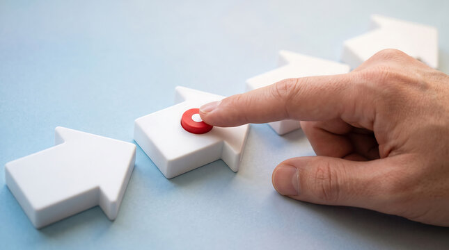 Hand pressing red button on white puzzle piece shaped switch symbolizing decision making process