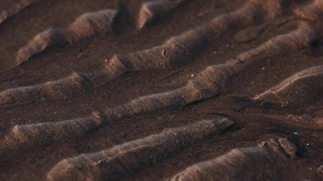 Magical natural patterns formed by sand on multicolored Hormuz Island beach, Iran. mineral sands including hematite, ilmenite, and magnetite create striking textures shorelineIn the Persian Gulf..