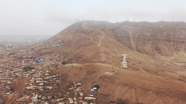Aerial view of the christ of the pacific monument on morro solar hill overlooking chorrillos, lima