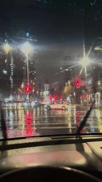 City Traffic Lights Reflected on Wet Road at Night