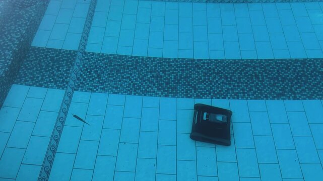 Robotic Pool Cleaner Submerged in Blue Swimming Pool
