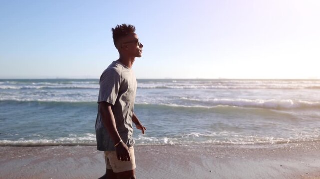 African American man with a disabled left hand enjoying a walk at the beach in Southern California. Slow Motion.