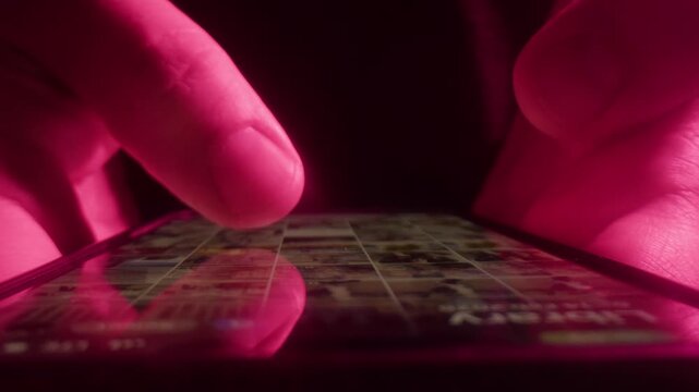 AI chat bot on phone, close up of hands typing prompt on smartphone screen in neon purple light, person using artificial intelligence assistant app at night