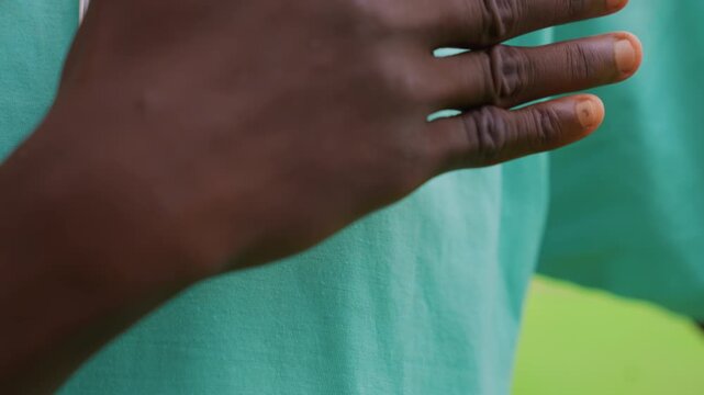 Focus on detailed lines in extended palm against teal clothing. Hand remains steady throughout emphasizing natural surface characteristics without movement or additional context