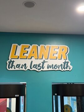 Fitness and weight loss motivation text on a health club wall