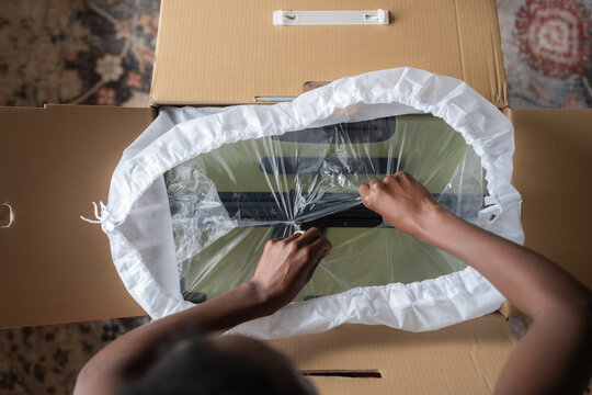 Woman unwrapping product at home