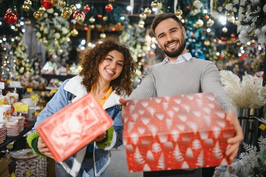 Happy couple shopping christmas gifts in store