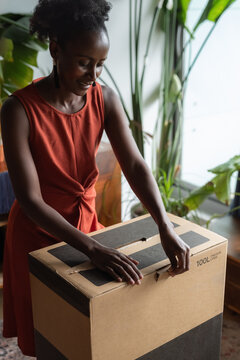 Woman unpacking her online order at home