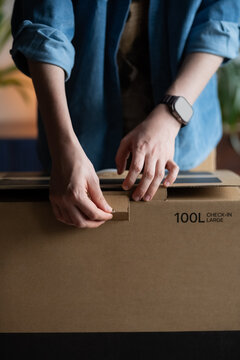 Man opening box with new suitcase