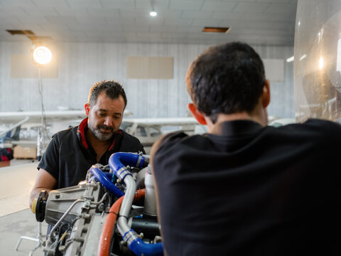 Colleagues repairing airplane together