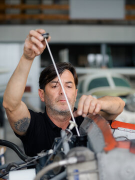 Man Checking Aircraft Engine Oil Level