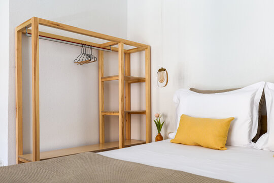 Empty rack awaits beside crisp white sheets