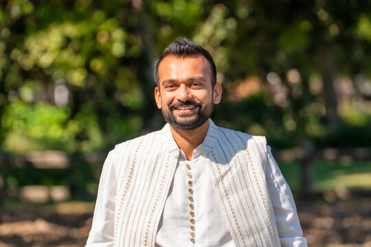 portrait indian man in white traditional outfit