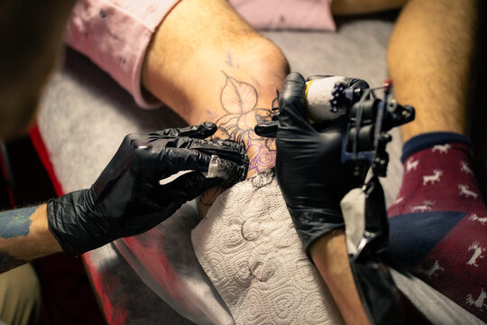 Tattoo artist using machine while working