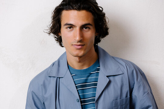 Young man with a confident gaze looking at the camera, determined.