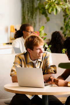 Office worker chatting with a colleague in a modern coworking space.