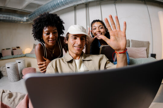 Coworkers using a laptop to make a video call with their colleagues