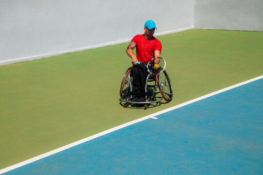 Wheelchair Tennis Athlete Playing On Outdoor Court