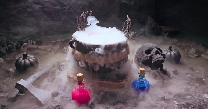 Witch cauldron emits smoke beside magic potions and skull.