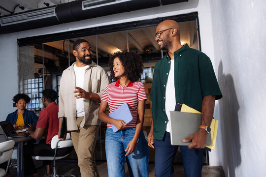 Diverse Colleagues Walking and Smiling in Office
