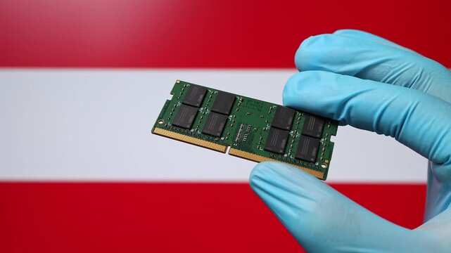 Close up view of hand in blue glove holding RAM memory microchip module. Austrian flag in blurred background. Concept of semiconductor shortage, artificial intelligence development in Austria.