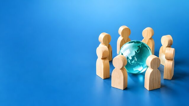 International business team unity concept featuring a circle of wooden figures surrounding a glass earth globe on solid blue background
