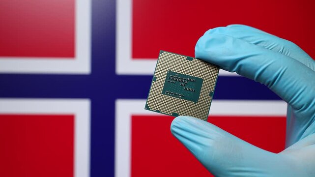 Close up view of hand in blue glove holding CPU microchip. Norwegian flag in blurred background. Concept of semiconductor shortage and artificial intelligence development in Norway.
