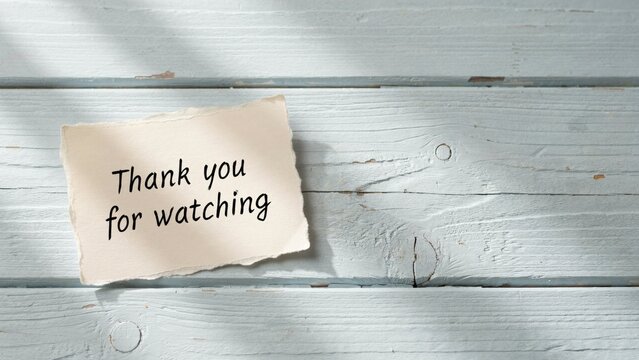 Rustic paper note with thank you for watching text, vintage blue wooden background message, video outro sign for social media end screen