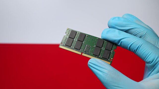 Close up view of hand in blue glove holding RAM memory microchip module. Polish flag in blurred background. Concept of semiconductor shortage, artificial intelligence development in Poland.