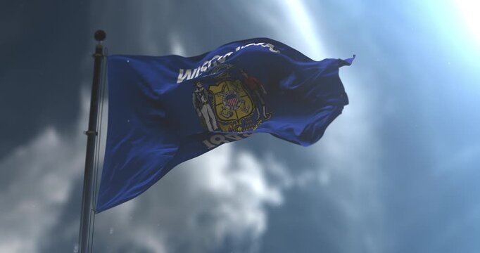 Wisconsin state flag waving on mast against dramatic sky