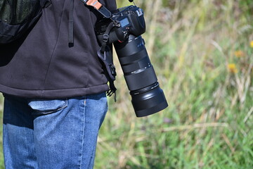 Photographer with a Camera and Large Telephoto Lens © Miroslaw