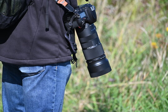 Photographer with a Camera and Large Telephoto Lens