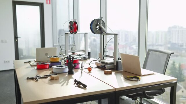A bright and organized workspace featuring 3D printers and tools for creative projects