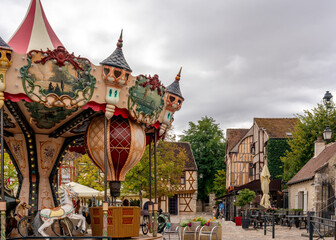 France: Decorative Jules Verne themed carousel on Place du Châtel in the medieval city of Provins, with thalf-timberd-houses in the background. © Angela Meier