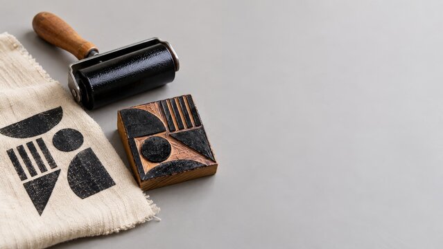 Geometric Printing Block with a Black Brayer and Printed Linen