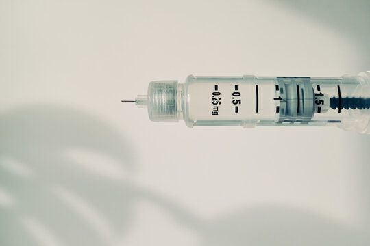 Medical GLP-1 pen syringe displaying dosage for patient healthcare and injection