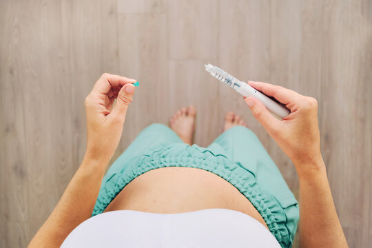 Woman preparing GLP-1 medication injection for self-administration, weight loss treatment and diabetes care