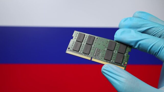 Close up view of hand in blue glove holding RAM memory microchip module. Russian flag in blurred background. Concept of semiconductor shortage, artificial intelligence development in Russia.