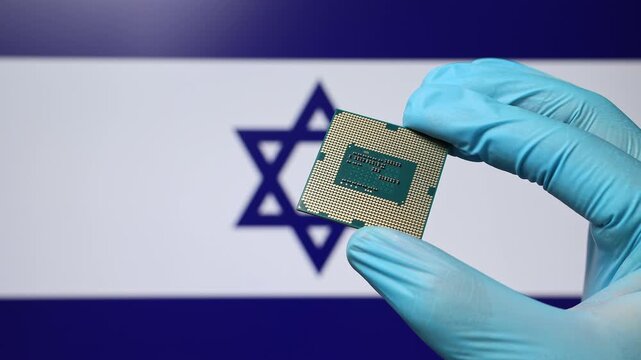 Close up view of hand in blue glove holding CPU microchip. Israeli flag in blurred background. Concept of semiconductor shortage and artificial intelligence development in Israel.