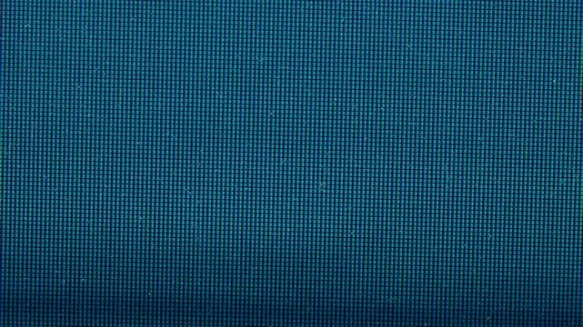 macro video footage of a television screen displaying a defective digital signal. Individual RGB pixels and subpixel patterns are clearly visible, combined with subtle interference, distortion.
