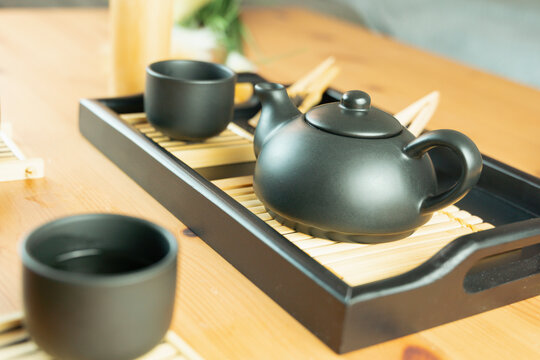 chinese tea ceremony gongfu tea set chahu teapot pinming cups on chaban tray, side view on wooden table with blurred background and copy space for banner design concept of tea culture, restaurant