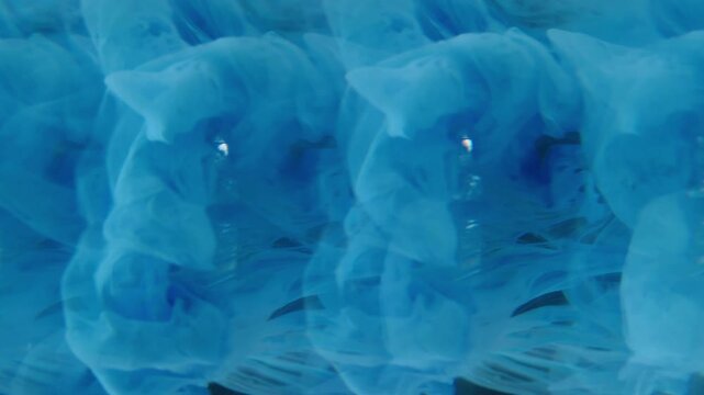 Vertical video. Smoke color stream. Dye blend. Blue blob on crystal glow sphere. Ink drip mix defocused prism effect liquid abstract background.