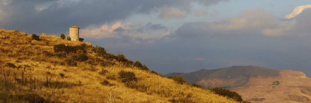 All around, panorama shot, evening light, autumn hill landscape, brown fields, dramatic cloudy sky, Madonie National Park, autumn, late summer, Sicily, Italy