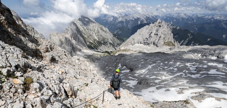 Hikers on the Hermann von Barth trail, via ferrata to the Partenkirchner Dreitorspitze, view of the Leutascher Platt with peaks &Ouml;felekopf and Musterstein and T&ouml;rlspitzen, Wetterstein range, Bavaria, Germany