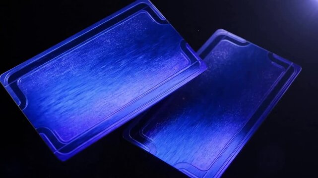 Blue playing cards cascade downward against a dark background revealing their faces playingcards deckofcards cardgame gambling