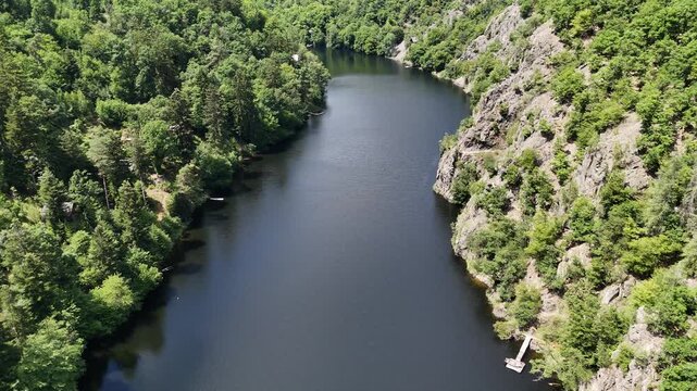 Drone Shot of the Vltava River Winding Through Lush Green Forests and Rocky Nature in Central Bohemia. Trees and Water in Czech Republic.