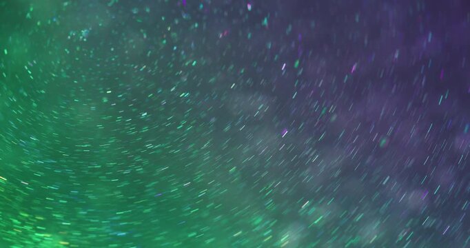 Blur kaleidoscope. Glitter texture. Purple green neon colorful round illuminated luminous circling on abstract bokeh art background.