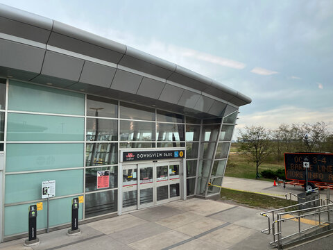 Modern glass and steel exterior of Downsview Park TTC subway station entrance with Presto readers as seen from GO train, September 2026