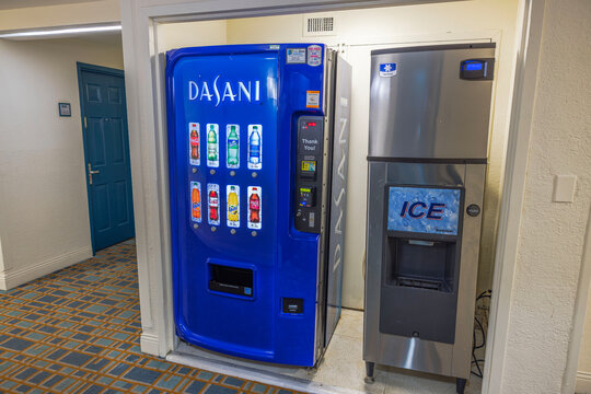 Close-up view of Dasani drink vending machine beside Manitowoc ice maker with Scotsman dispenser. Miami Beach. USA. 